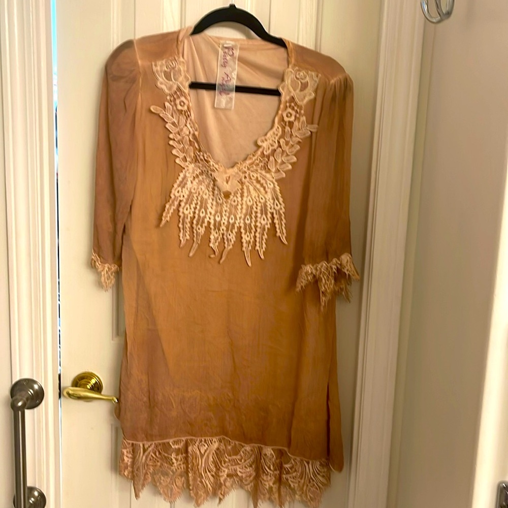 This is a beautiful sheer top that would look great with jeans or leggings.